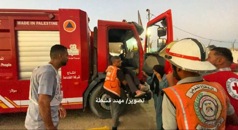 Civil defense teams transport martyrs and injured after the bombing of a tent to the Khafaga family