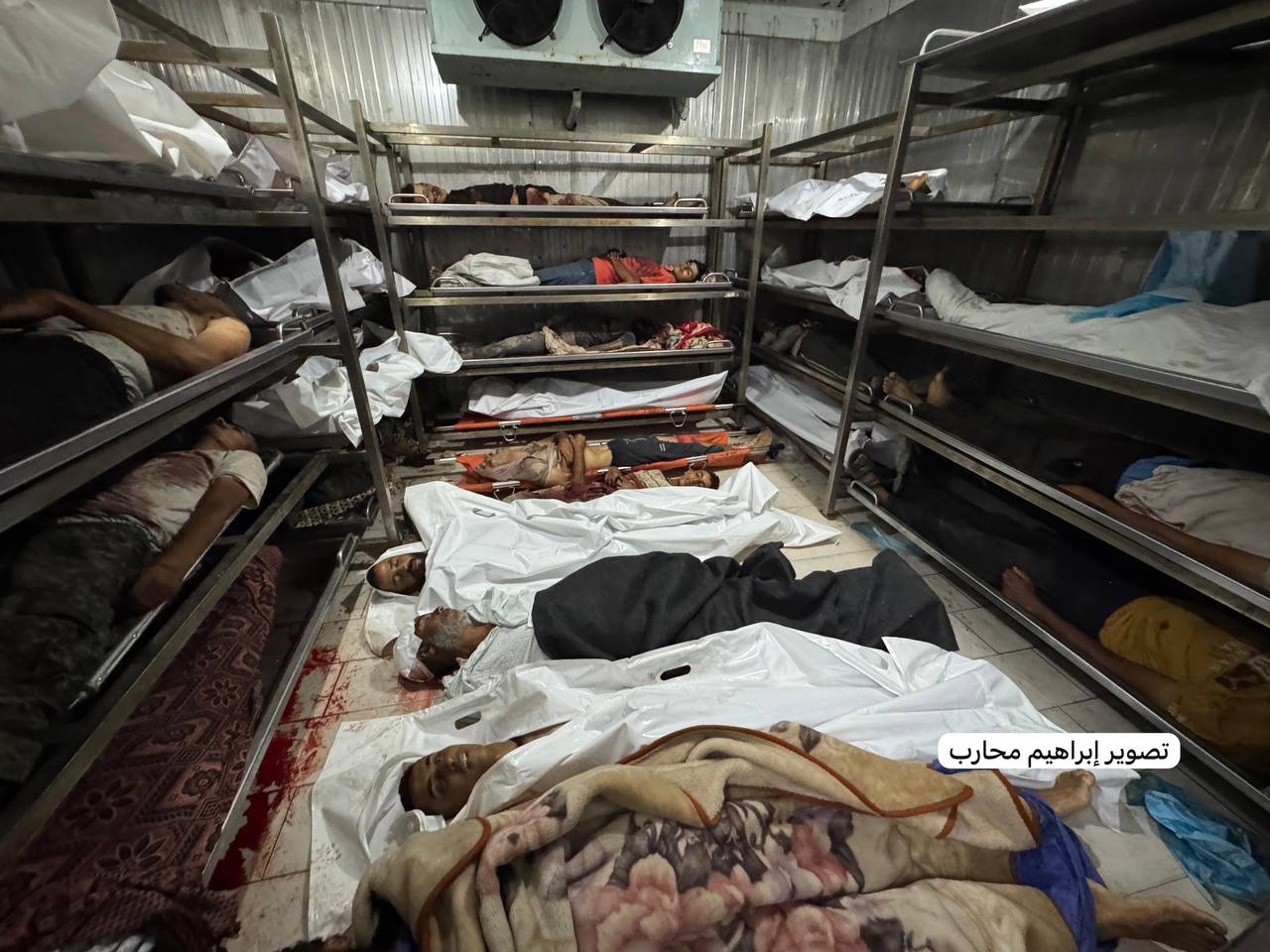 The martyrs were accumulated outside the dead refrigerator in the Nasser Medical Complex, after the