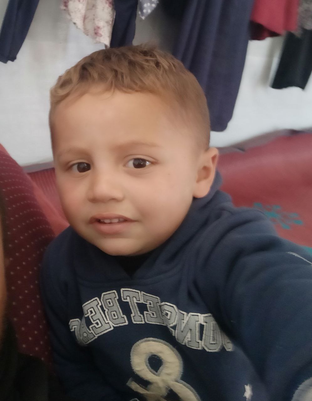 The loss of the child, Ahmed Bakr, is 3 years old, wearing blue trousers and a navy blouse missing t