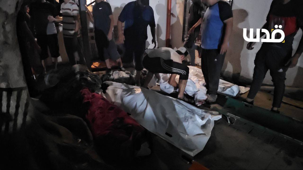 The bodies of the martyrs of the occupation massacre after bombing a house for the "Jouda" family an